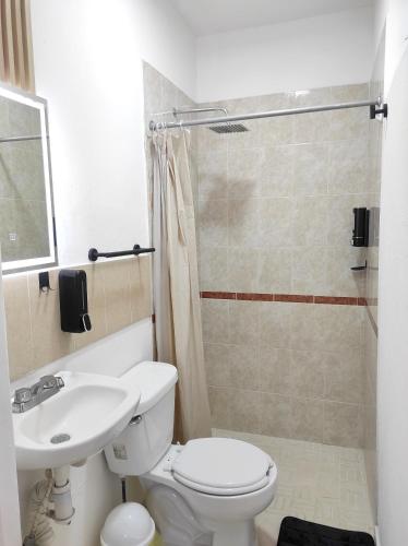 a bathroom with a white toilet and a sink at Departamento Privado in Guadalajara