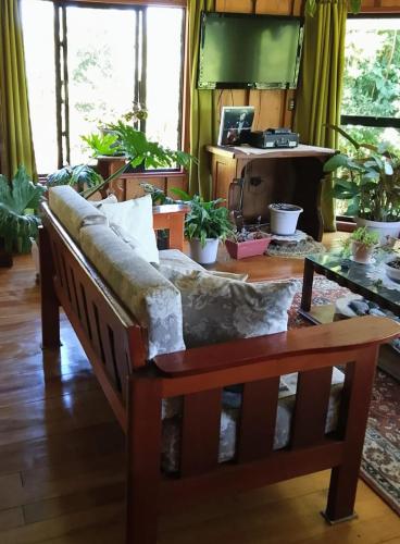 a living room with a couch and a table at Hostal los arrayanes in Puerto Carmen
