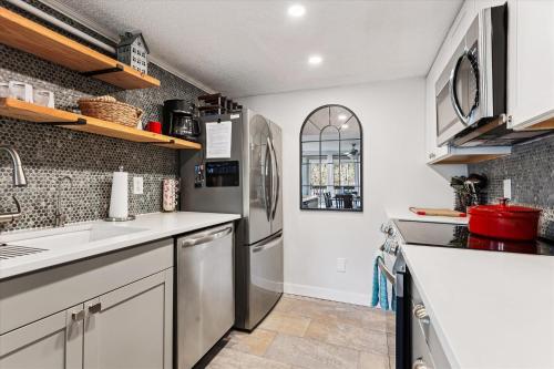 a kitchen with a sink and a refrigerator at The Summit at Mountainside in Stowe