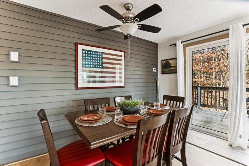a dining room with a table with a flag on the wall at The Summit at Mountainside in Stowe