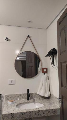 a bathroom with a sink and a mirror at Central Apartment 2 in Ouro Preto