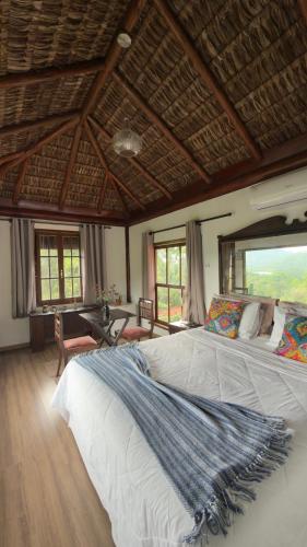 a bedroom with a large bed with a wooden ceiling at Cinque Terre Pousada & Bistrô in Rio de Janeiro