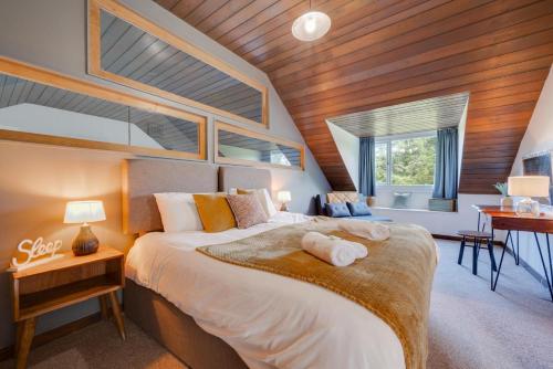 a bedroom with a large bed with a wooden ceiling at 4 Bed in Ffestiniog oc-bow172 in Ffestiniog