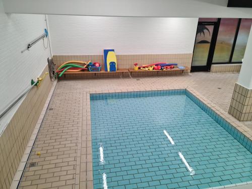 a swimming pool in a building with at Bayer Apartments Copenhagen in Tåstrup
