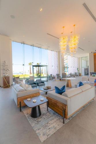 a large living room with couches and a table at Sonoran Star Signature 3-Bedroom Beachfront Luxury Condominium in Puerto Peñasco