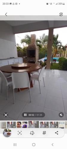 a screenshot of a picture of a table and chairs at Casa da Lelê in Acaraú