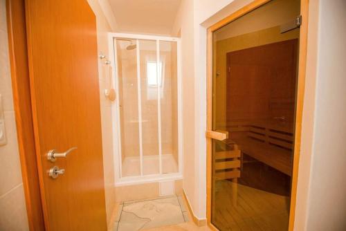 a bathroom with a shower and a glass door at Vanilka in Liptovský Trnovec