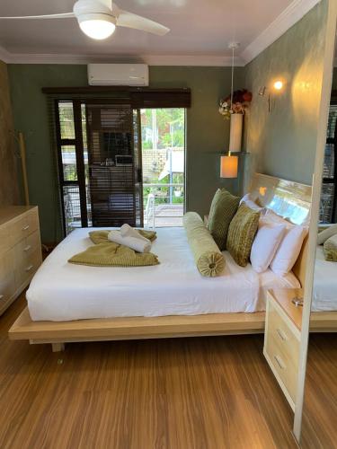 a bedroom with a large bed with white sheets and pillows at The View on Nyle Rustenburg in Rustenburg