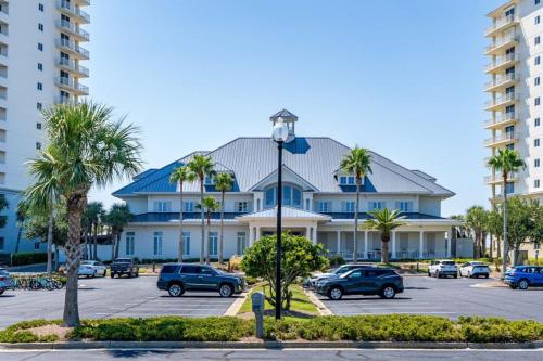 a large building with cars parked in a parking lot at Beach Club 806A by Youngs Suncoast in Gulf Highlands