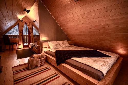 a bedroom with a bed in a log cabin at Kakerdaja Private Sauna in Vose