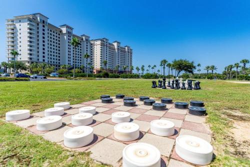 a chess board in a field with buildings in the background at Beach Club 806A by Youngs Suncoast in Gulf Highlands