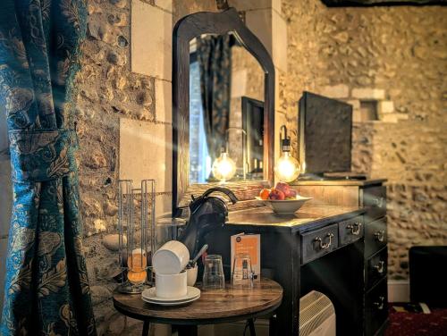 a bathroom with a table with a sink and a mirror at Hitchin Priory Hotel in Hitchin