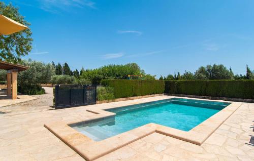 a swimming pool in a yard with a fence at Es Cipres in Porreres
