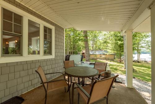 a porch with a table and chairs on it at Smooth Sailing by Railey Vacations in Swanton