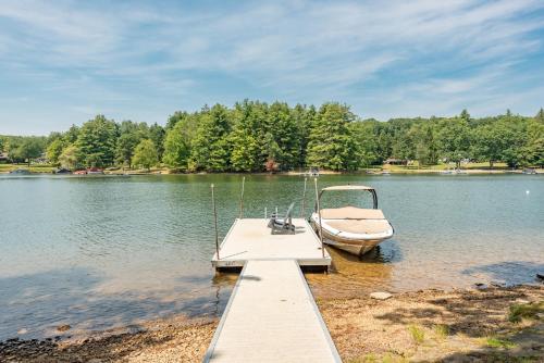 a boat is docked at a dock on a lake at Smooth Sailing by Railey Vacations in Swanton