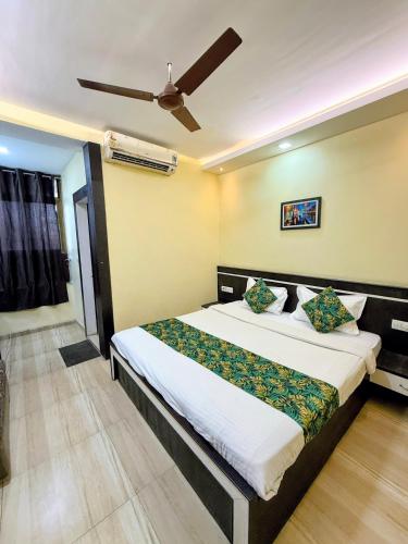a bedroom with a bed and a ceiling fan at Hotel Wardhman in Jabalpur