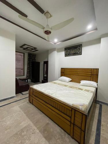 a bedroom with a large bed in a room at Own It Hotel in Islamabad