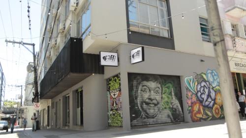 a building with graffiti on the side of it at Graffi City House in Florianópolis