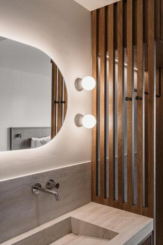a bathroom with a sink and a mirror at Sunny Bay Hotel in Kissamos