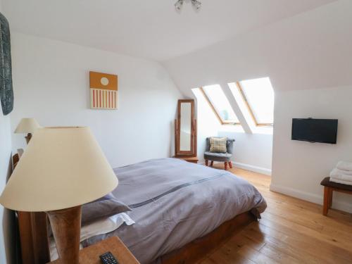 a bedroom with a bed with a lamp and a tv at Lurach House in Appin