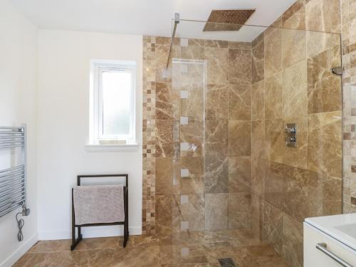 a bathroom with a shower with a glass door at Lurach House in Appin