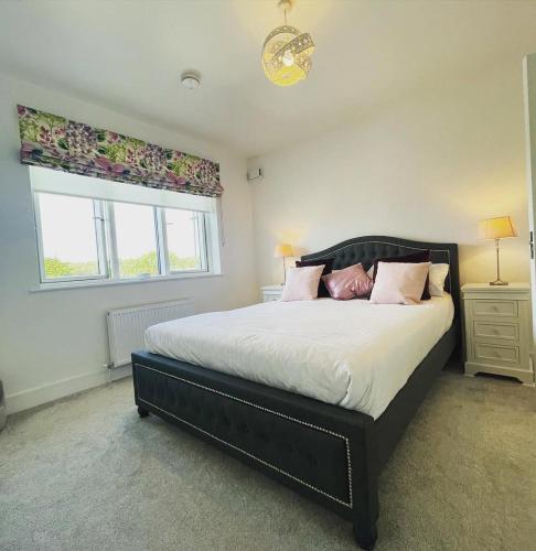 a bedroom with a large bed and a window at Manor Brook House in Adare