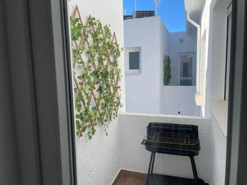 a black chair sitting on a balcony next to a building at Modern Apartment Near Golf, Beach & Marina in San Pedro del Pinatar