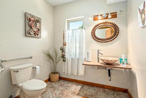 a bathroom with a toilet and a sink and a mirror at Slot Canyons Inn Bed & Breakfast in Escalante