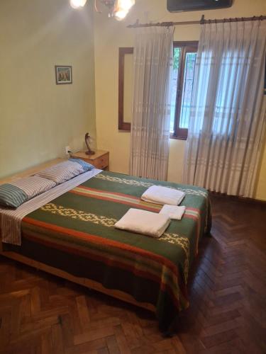a bedroom with a large bed with towels on it at Encanto en el centro salteño in Salta