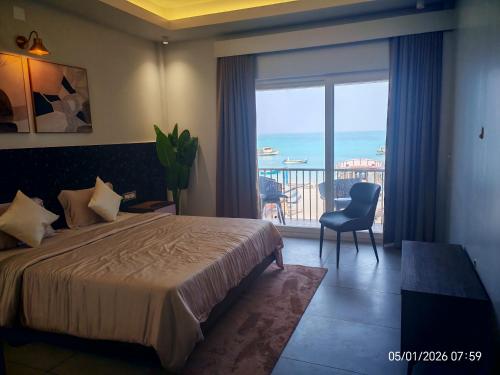 a bedroom with a bed and a view of the ocean at Horizon Nest in Agatti