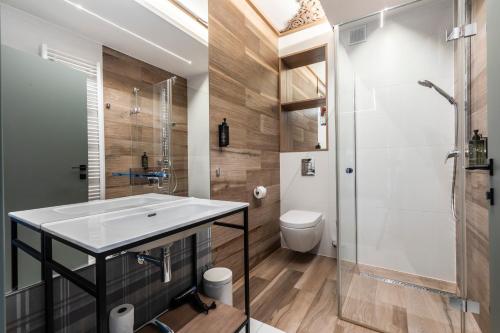 a bathroom with a sink and a shower and a toilet at Gerlach in Zakopane