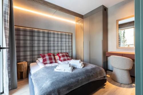 a bedroom with a bed with red pillows at Gerlach in Zakopane