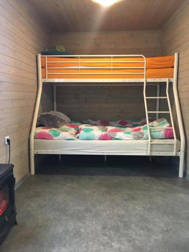 a bunk bed in a corner of a room at Chata Bítov in Bítov