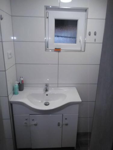 a bathroom with a white sink and a mirror at Chata Bítov in Bítov