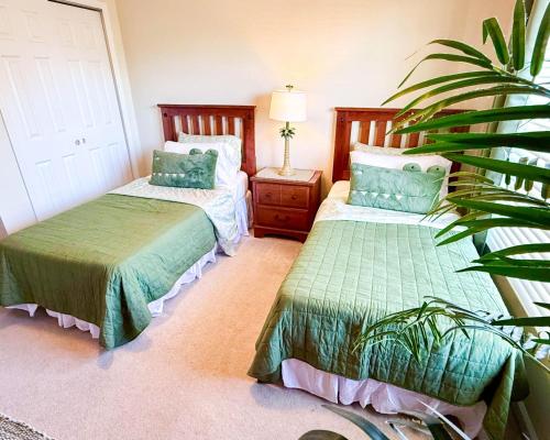 a bedroom with two beds and a plant at WH7783TB-Windsor Hills- 10 guests - in Orlando