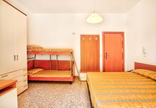 a bedroom with two bunk beds and a closet at Hotel Happy in Milano Marittima