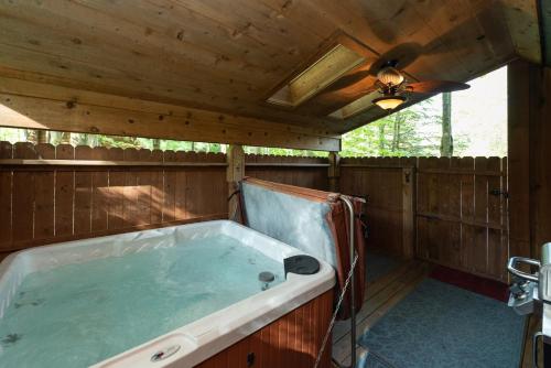 a large bath tub in a room with a ceiling at Tree Haus by Railey Vacations in Oakland