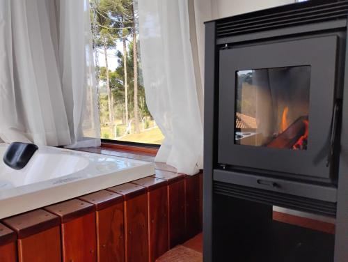a television in a room with a sink and a window at Pousada Anabela in Campo Alegre
