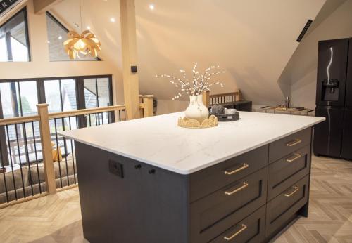 a kitchen with a island with a vase on it at Highland House in Lochearnhead