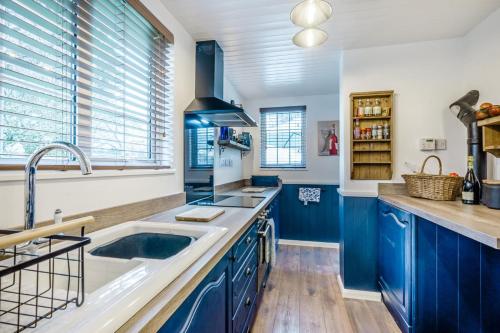 a kitchen with blue cabinets and a sink at 2 Bed in Wickhampton oc-t34449 in Wickhampton