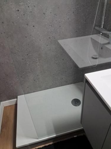 a white counter in a bathroom with a sink at 265 rue du clos capperony in Les Rousses
