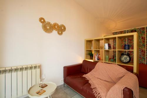 a living room with a couch and a book shelf at La cabanne aux bambous in Villenave-dʼOrnon