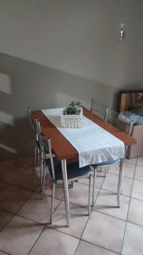 a dining room table with a plant on top of it at Casa Castel San Giovanni in Castel San Giovanni