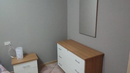 a bedroom with a dresser and a mirror on the wall at Casa Castel San Giovanni in Castel San Giovanni