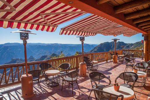 a patio with tables and chairs on a balcony at Hotel El Mirador - Balderrama Hotel Collection in Areponapuchi