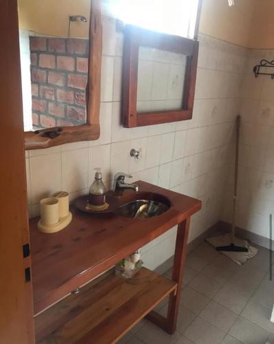 a bathroom with a wooden sink and a mirror at Torres del Piltri in El Bolsón