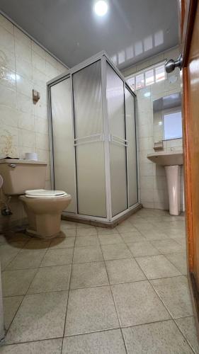 a bathroom with a toilet and a sink at Casa Turística Samanta in Buga