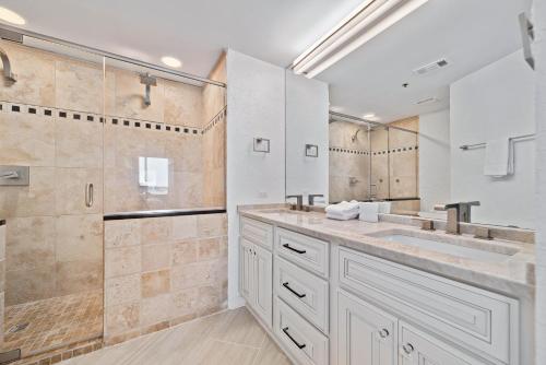 a bathroom with two sinks and a shower at Harbor Cove 404 in Orange Beach