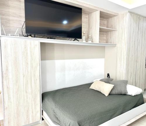 a bedroom with a bed with a flat screen tv at Sunset view luxury in Cedro
