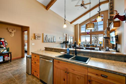 a kitchen with a sink and a large window at Blackrock 6 in Big White